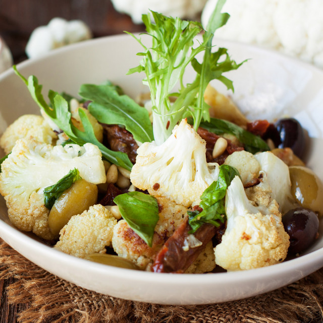 eine Schüssel mit Essen und einem Zweig von Grün
